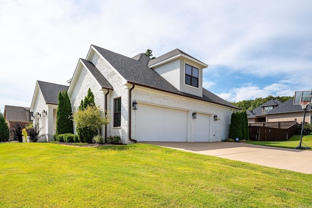 view of front of home with a garage and a front lawn