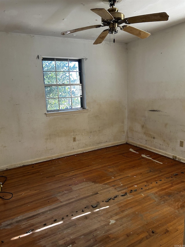 empty room featuring ceiling fan and dark wood-type flooring