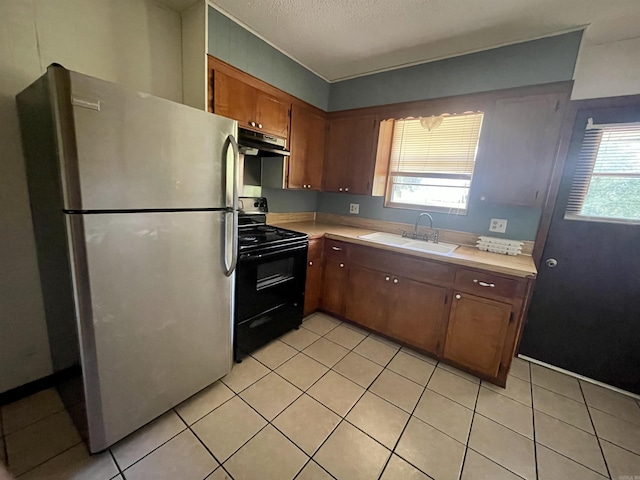 kitchen featuring black electric range oven, sink, stainless steel fridge, a textured ceiling, and range hood