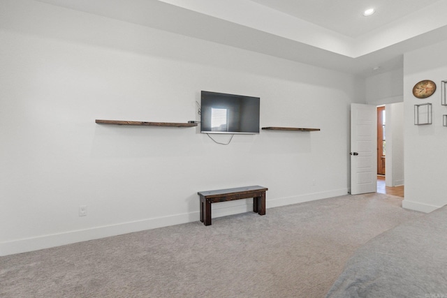 unfurnished living room featuring light carpet