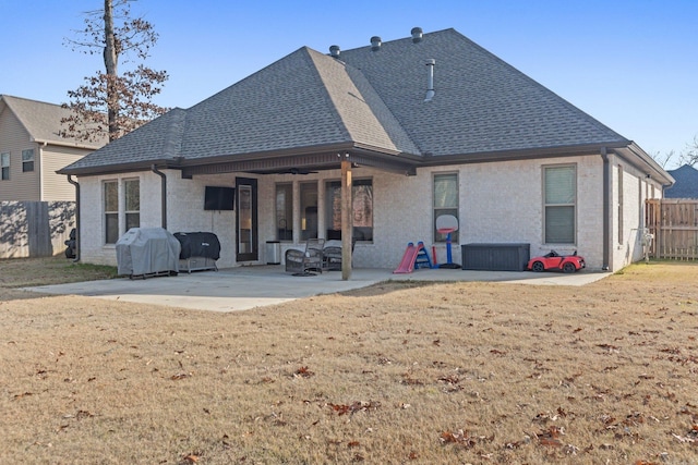 rear view of house with a patio area and a yard