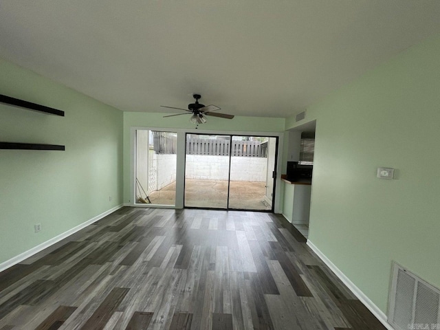 empty room with dark hardwood / wood-style flooring and ceiling fan