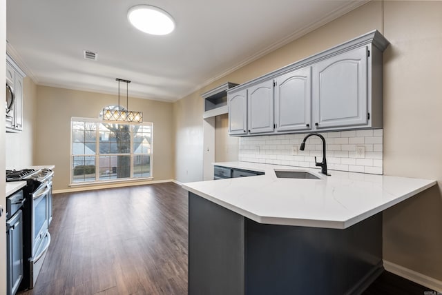 kitchen featuring gray cabinetry, light stone countertops, sink, kitchen peninsula, and stainless steel range with gas stovetop