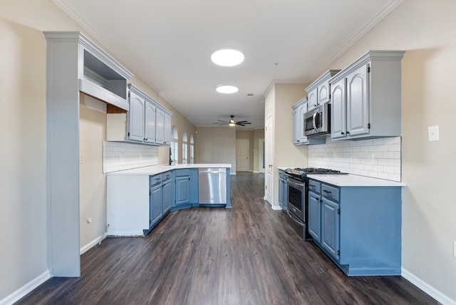 kitchen featuring appliances with stainless steel finishes, backsplash, dark hardwood / wood-style flooring, ceiling fan, and crown molding