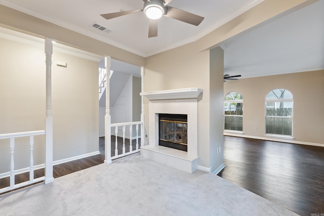 unfurnished living room featuring ceiling fan, dark carpet, and crown molding