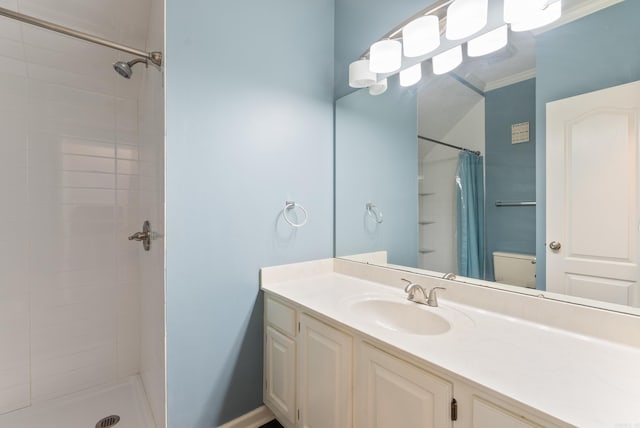 bathroom featuring vanity, toilet, curtained shower, and ornamental molding