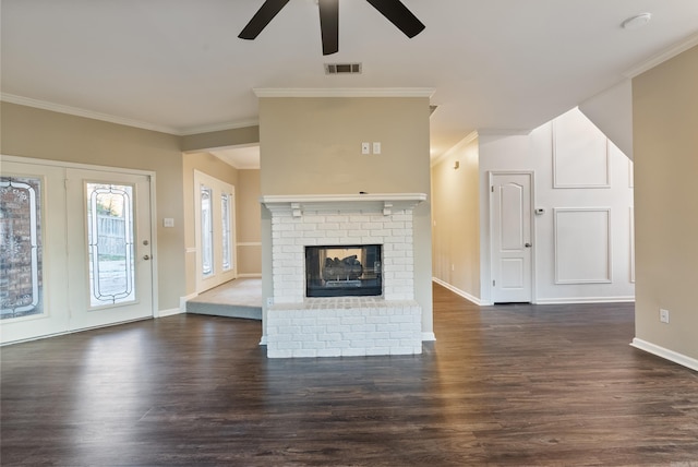 unfurnished living room with ceiling fan, dark hardwood / wood-style flooring, ornamental molding, and a fireplace