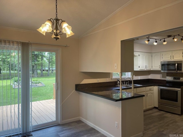 kitchen with white cabinetry, sink, stainless steel appliances, and vaulted ceiling