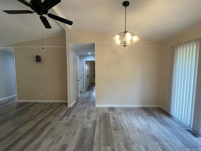 empty room featuring ornamental molding, ceiling fan with notable chandelier, a textured ceiling, vaulted ceiling, and dark wood-type flooring