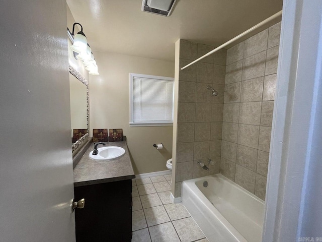 full bathroom featuring tile patterned flooring, vanity, toilet, and tiled shower / bath combo