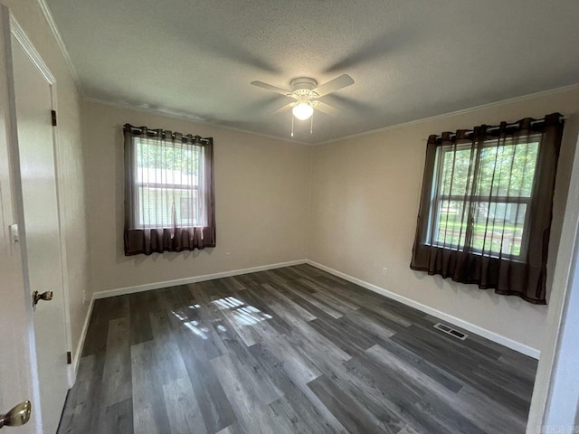 unfurnished room featuring a textured ceiling, ceiling fan, dark hardwood / wood-style floors, and ornamental molding