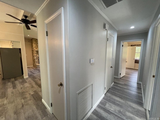 corridor featuring dark hardwood / wood-style floors and ornamental molding