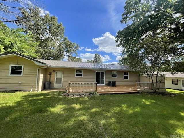 back of house with central air condition unit, a yard, and a deck