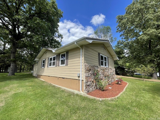 view of side of home featuring a lawn