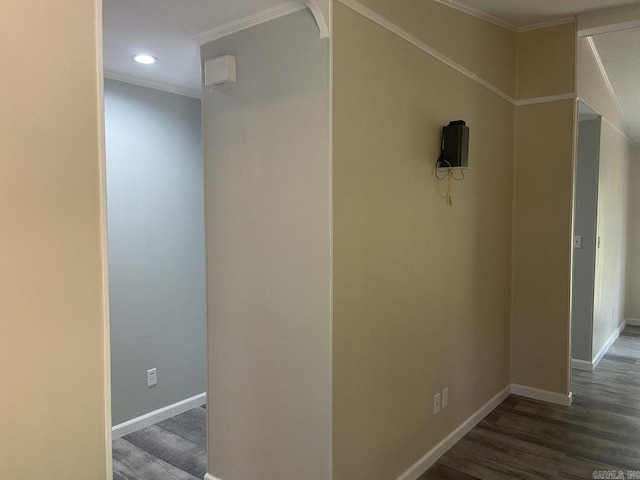 hall with ornamental molding and dark wood-type flooring