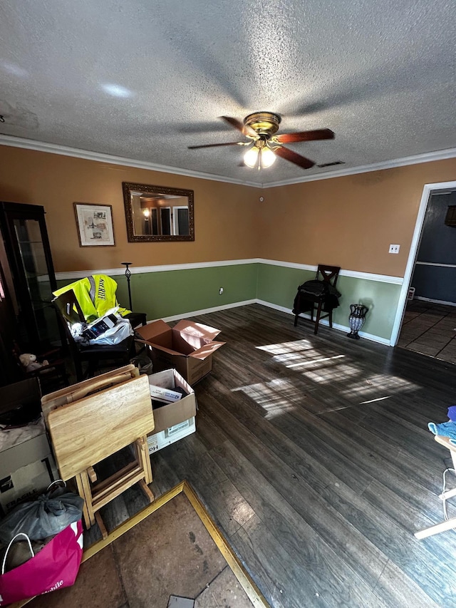 sitting room featuring a textured ceiling, dark hardwood / wood-style flooring, ceiling fan, and ornamental molding