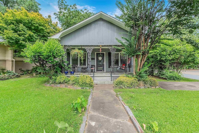 bungalow-style home featuring a porch and a front lawn