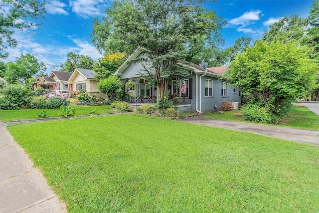 view of front of house with a porch and a front lawn