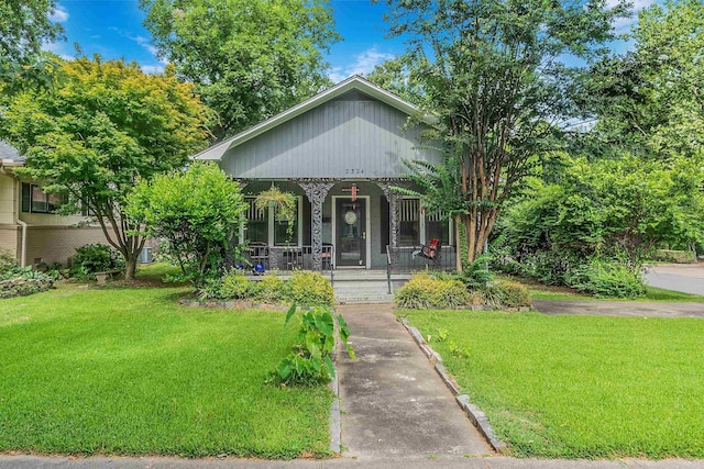 bungalow-style house with a porch and a front lawn