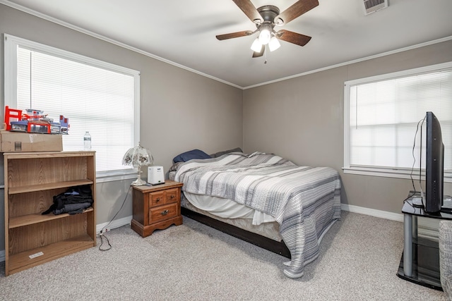 carpeted bedroom with multiple windows, ceiling fan, and ornamental molding