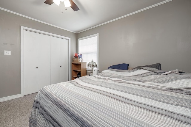 carpeted bedroom with ceiling fan, crown molding, and a closet