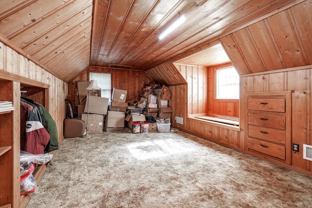 additional living space with carpet flooring, wood walls, wood ceiling, and vaulted ceiling