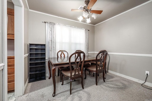 dining room with carpet flooring, ceiling fan, and ornamental molding