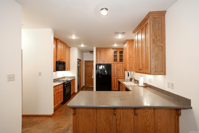 kitchen with kitchen peninsula, sink, and black appliances