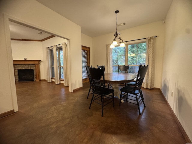 dining room featuring a fireplace and an inviting chandelier