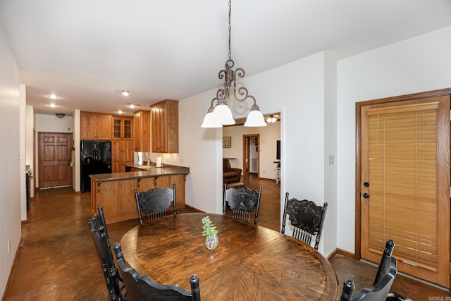 dining area with a notable chandelier and sink