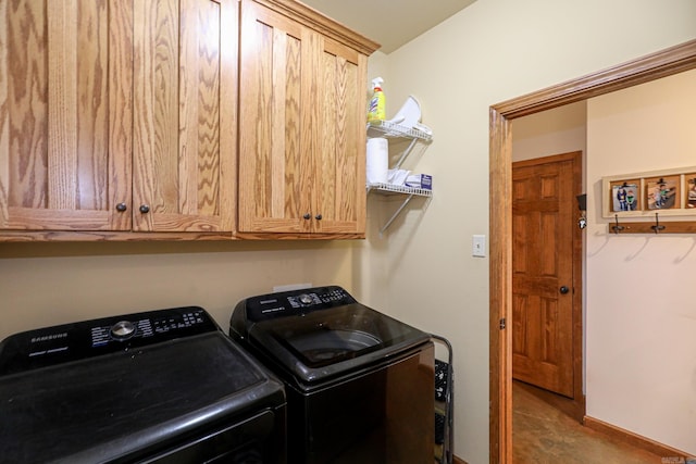 washroom featuring washer and dryer and cabinets