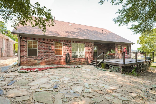 rear view of property with a patio and a wooden deck