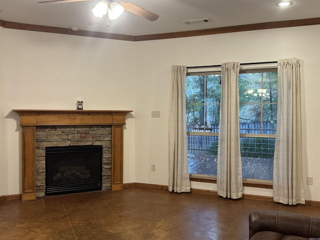 unfurnished living room featuring a stone fireplace, ceiling fan, and ornamental molding