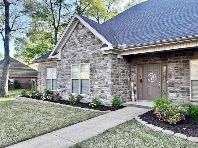 doorway to property with a yard