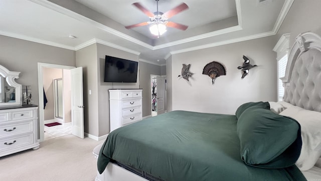 bedroom with a tray ceiling, ceiling fan, light carpet, and ornamental molding