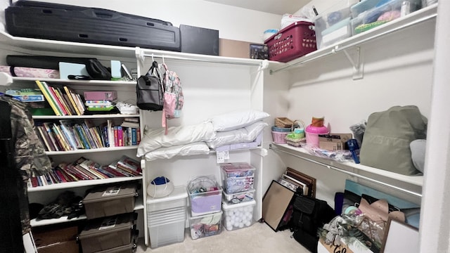 walk in closet featuring light colored carpet