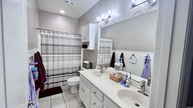 bathroom featuring tile patterned flooring, vanity, and toilet