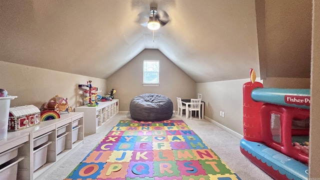 recreation room featuring light carpet and vaulted ceiling