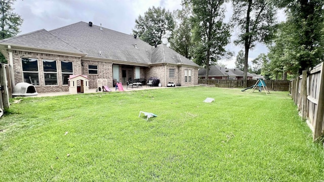 view of yard with a patio area and a playground