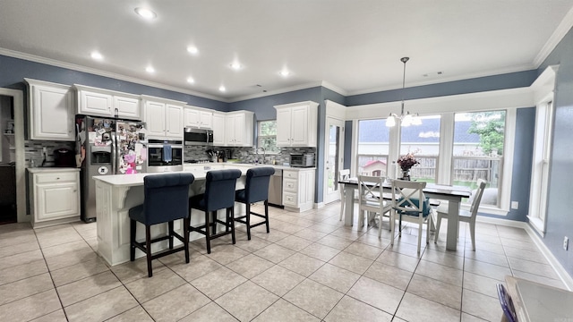 kitchen featuring white cabinetry, a center island, stainless steel appliances, backsplash, and light tile patterned flooring