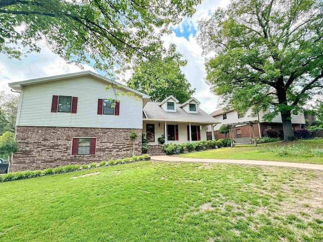 split level home featuring a porch and a front yard