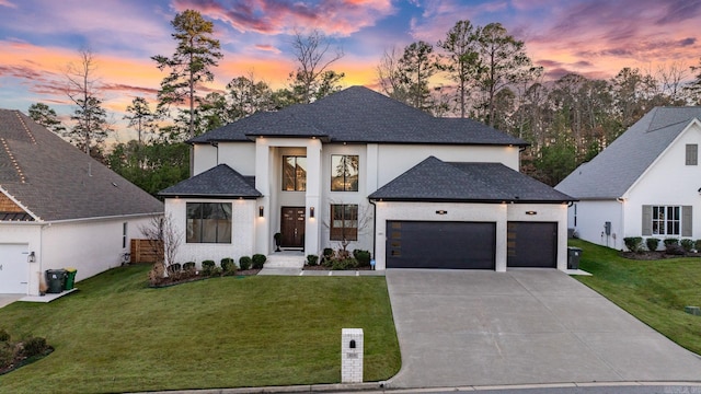 view of front facade with a lawn and a garage