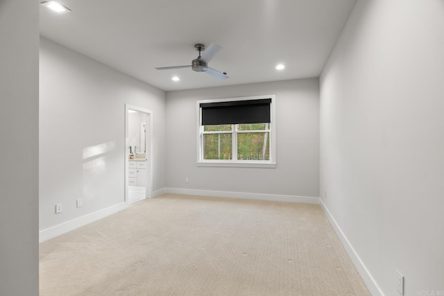 unfurnished room featuring light carpet and ceiling fan