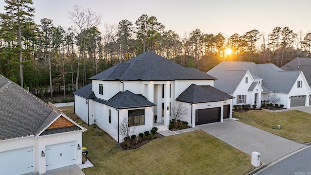 view of front of house with a garage and a yard