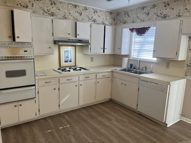 kitchen featuring white appliances, ventilation hood, sink, white cabinets, and dark hardwood / wood-style floors