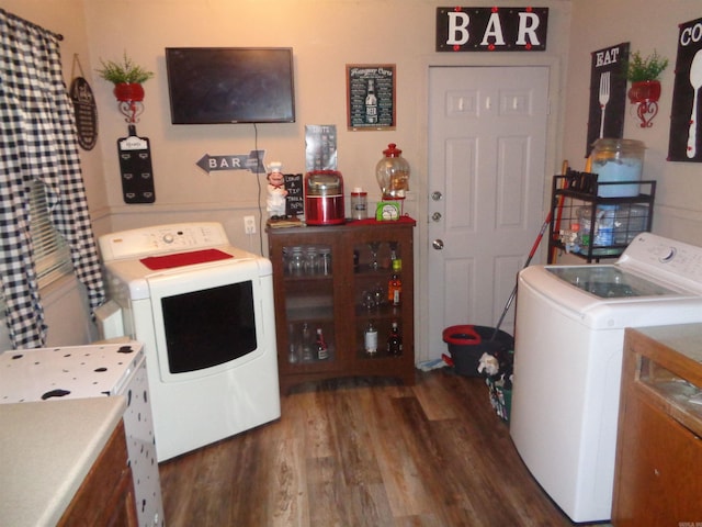 laundry area featuring washing machine and dryer and dark hardwood / wood-style flooring