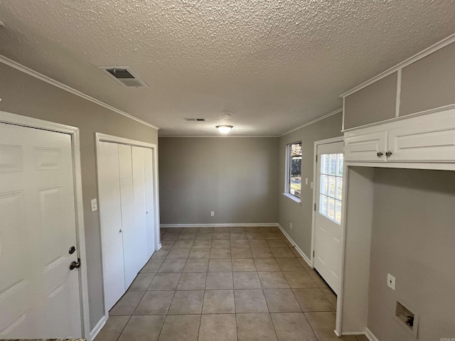 interior space featuring ornamental molding and a textured ceiling