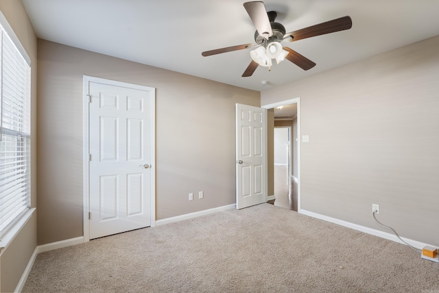 unfurnished bedroom with light carpet and ceiling fan