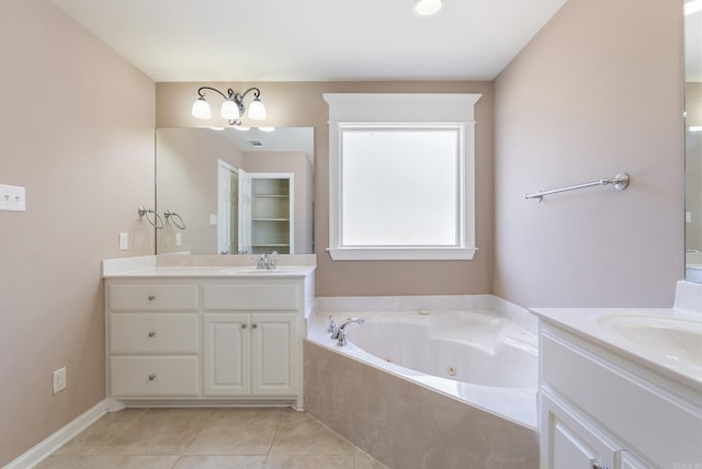 bathroom featuring tile patterned flooring, vanity, and a bath