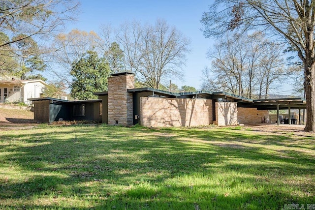 rear view of house with a yard